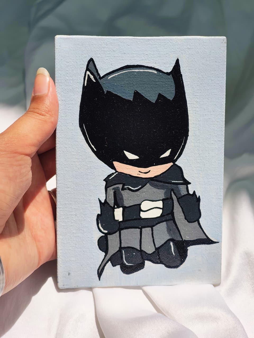 Handmade Batman canvas painting with chibi artwork on a light blue background, acrylic superhero wall art perfect for Batman collectors and comic-themed décor.