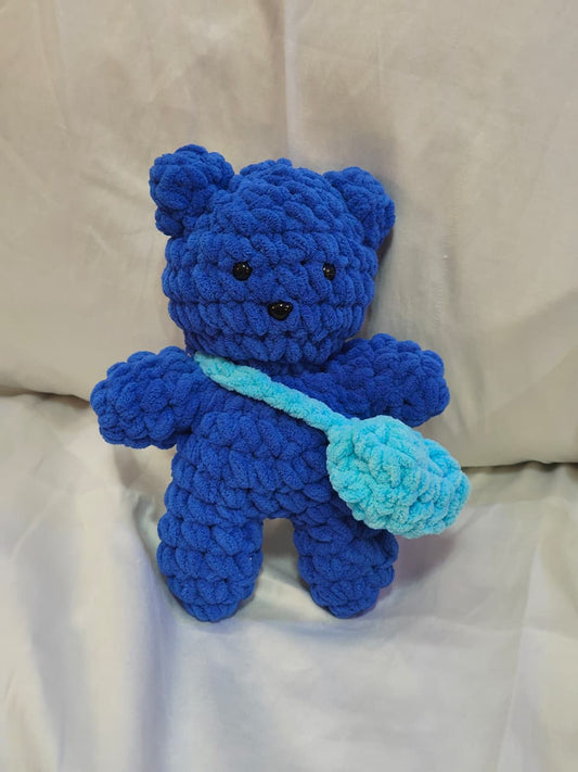 Blue handmade crochet teddy bear crafted with ultra-soft blanket yarn and matching crochet shoulder bag.
