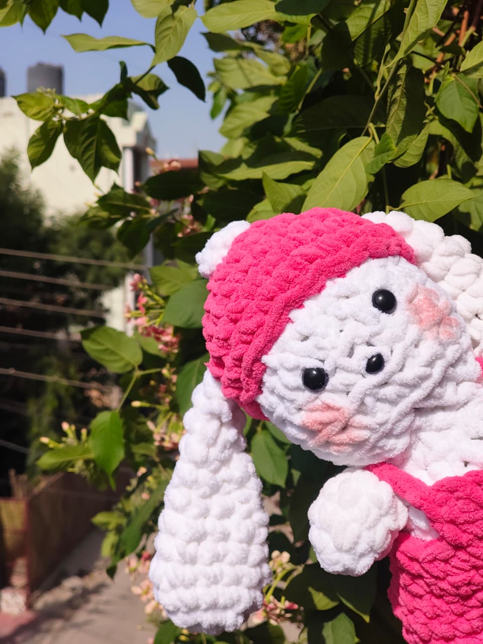 Cute handmade crochet bunny plush crafted with soft chenille yarn, amigurumi rabbit stuffed toy in pink outfit for room décor and baby gifts.