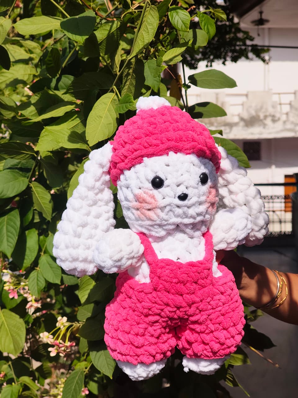 Crocheted toy with pink hat 