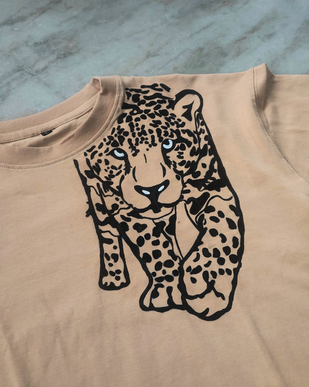 Unique hand-painted animal print beige T-shirt with washable fabric artwork.
