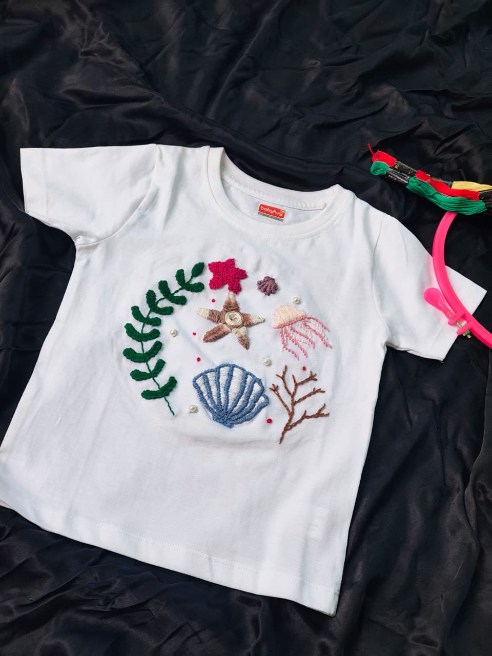 Customized handmade embroidered kids t-shirt featuring seashell, starfish and jellyfish.