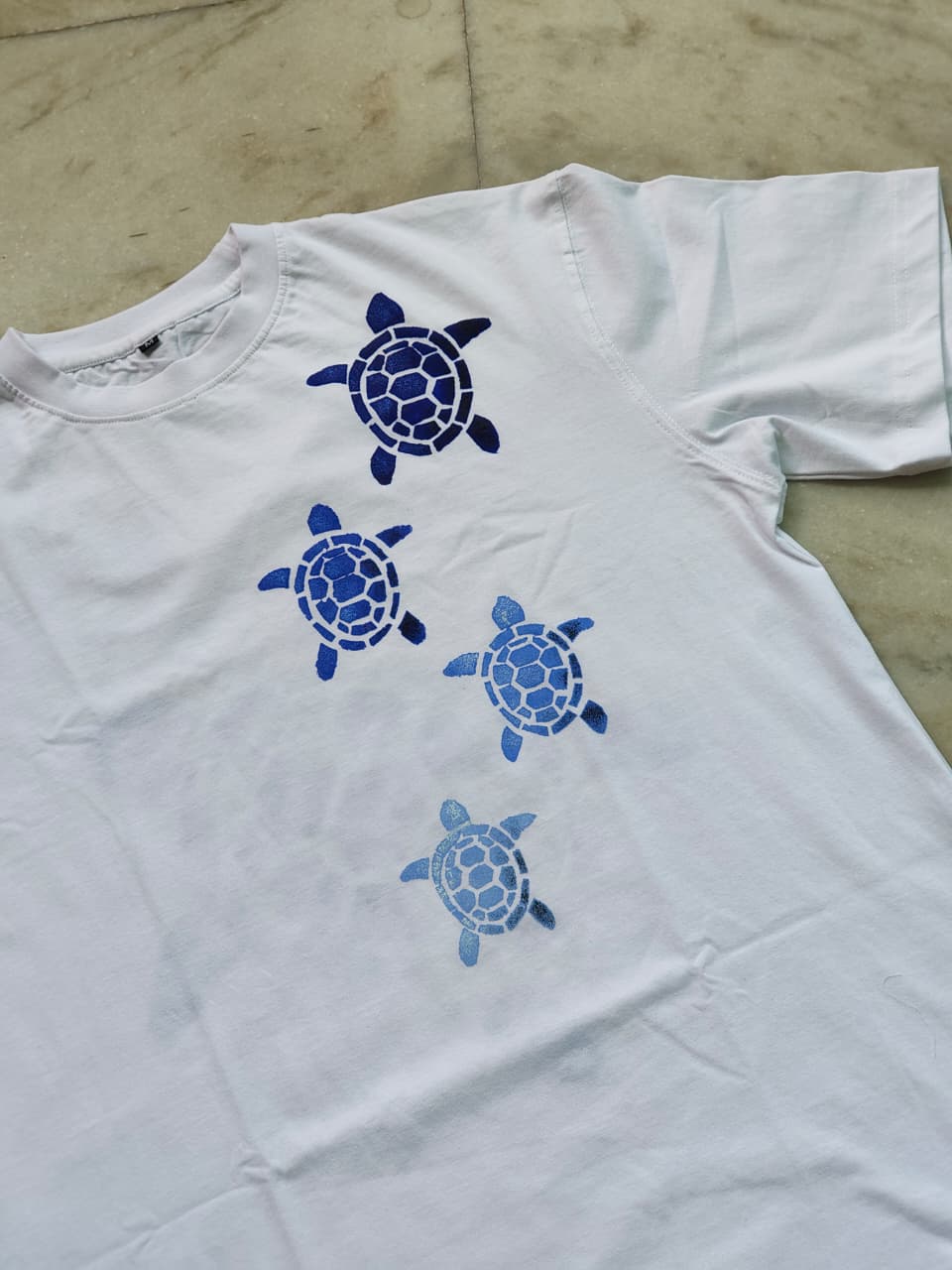Premium cotton hand-painted turtle t-shirt featuring unique ocean-inspired artwork on both sides.