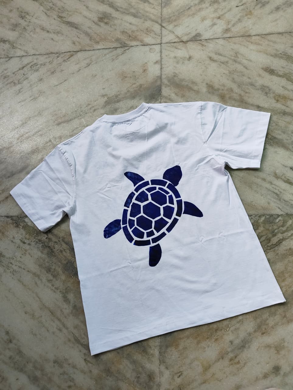 White oversized hand-painted turtle t-shirt with handcrafted sea turtle design on front and back.