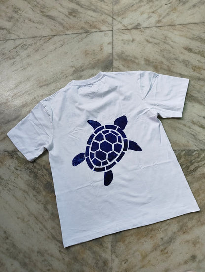 White oversized hand-painted turtle t-shirt with handcrafted sea turtle design on front and back.