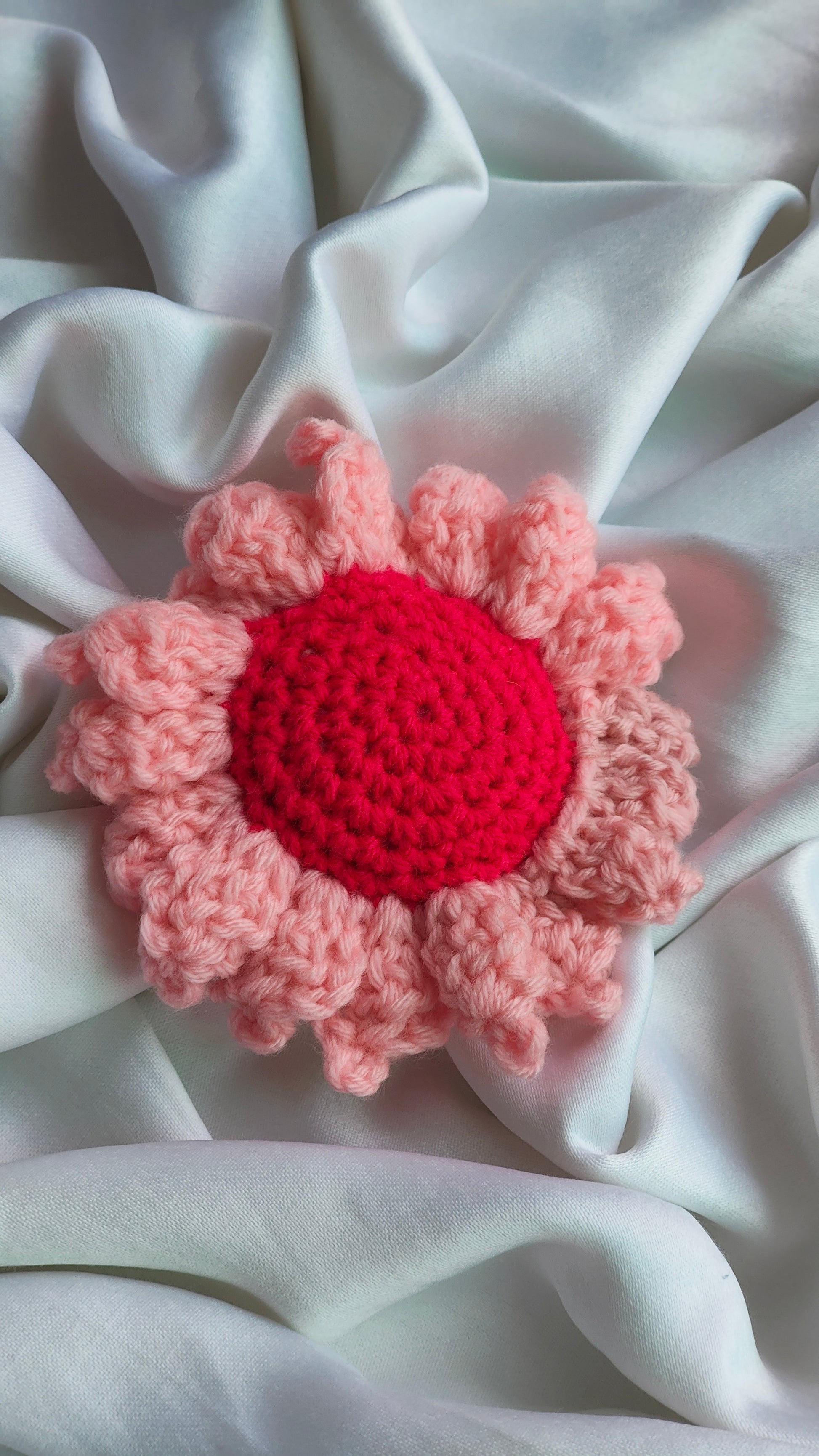 Crocheted flower with pink petals and hot pink in center hair clip