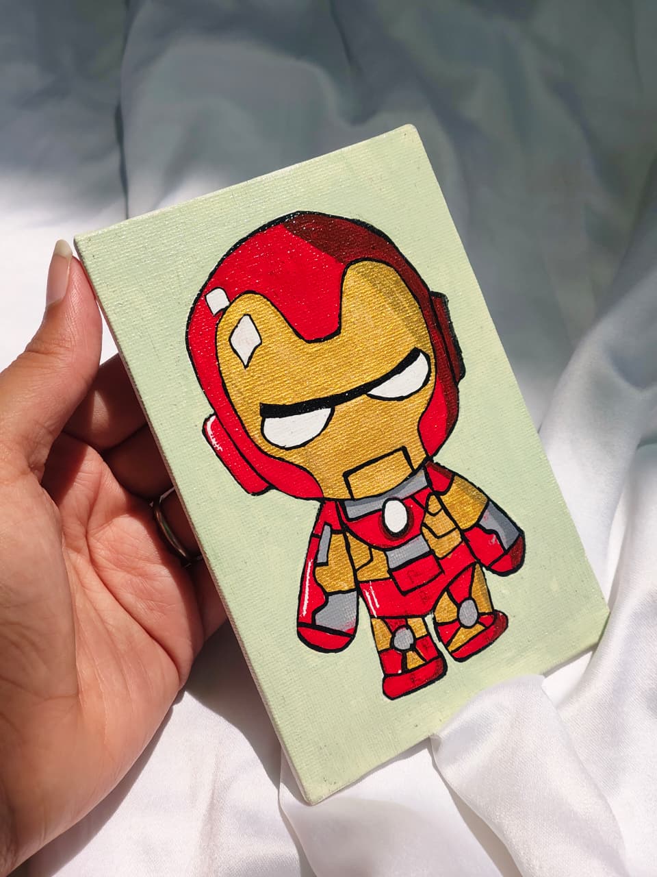 Handmade Iron Man canvas painting featuring a colorful superhero design on a mini canvas, ideal for kids room decor and Marvel fans.