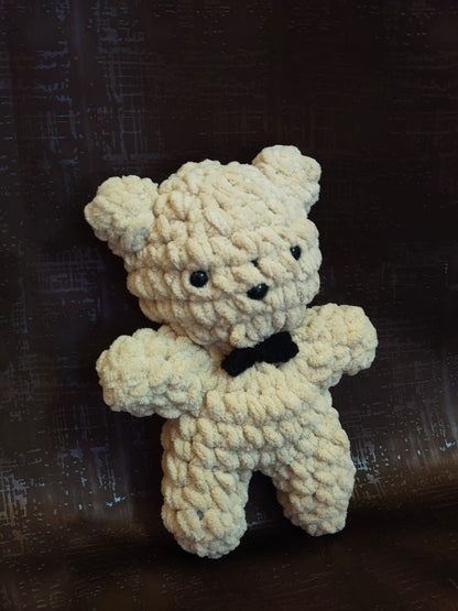 Cute handmade crochet teddy bear plush with black bow tie ideal for plush collections and unique handmade gifts.